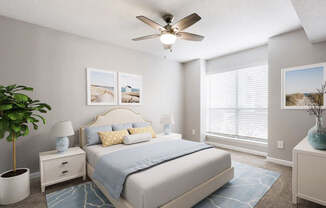 A bedroom with a bed, nightstands, a plant, and pictures on the wall.
