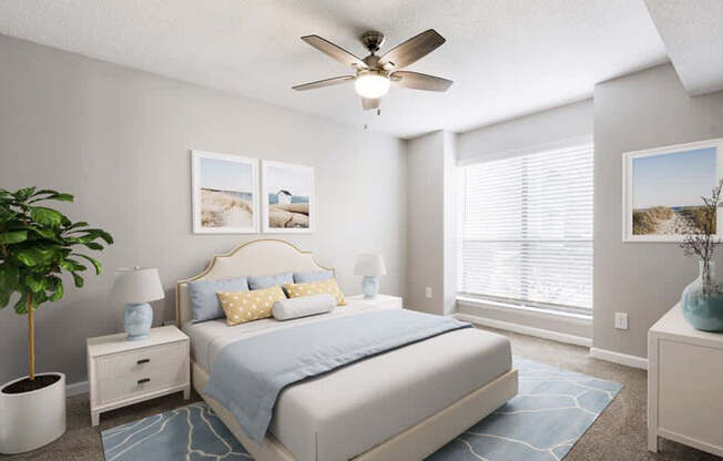 A bedroom with a bed, nightstands, a plant, and pictures on the wall.