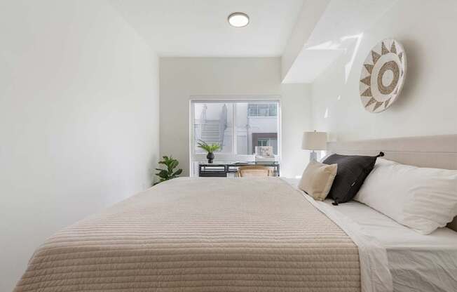 a bedroom with a large bed and a window