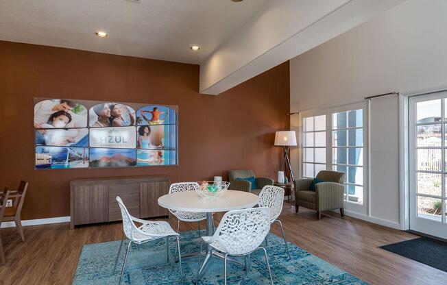 A dining room with a white table and chairs.