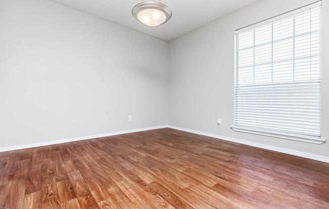 a bedroom with a wooden floor