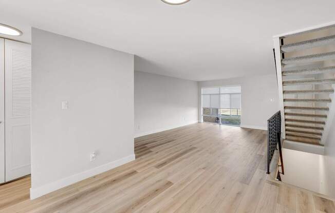 A room with wooden floors and white walls.