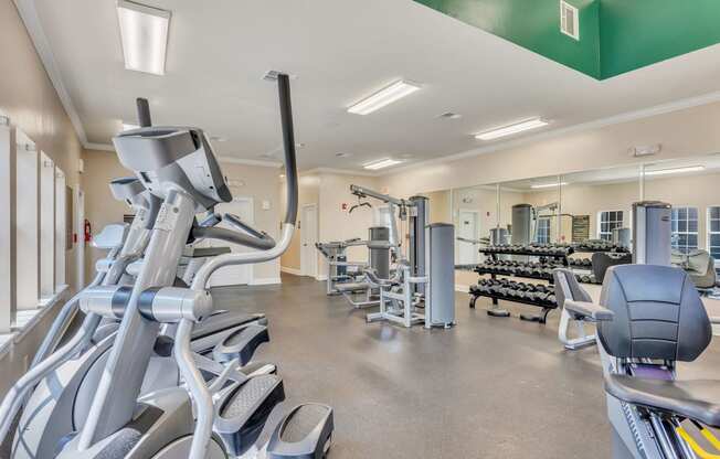 a gym with cardio equipment and weights at the village