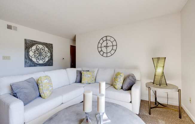 Living room of a two-bedroom model unit at Olde English Village, featuring cozy furniture and an open layout.