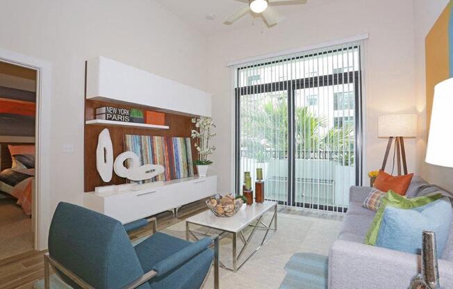 a living room with furniture and a sliding glass door