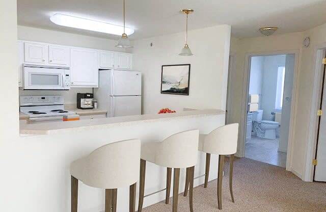 a kitchen with white cabinets and a counter top