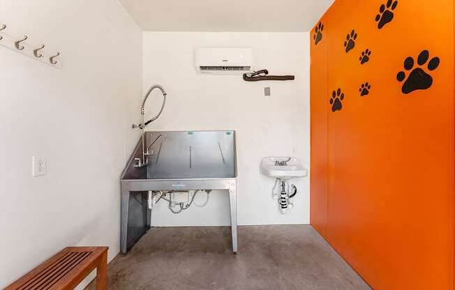 A room with a sink and a table with a grill on it.