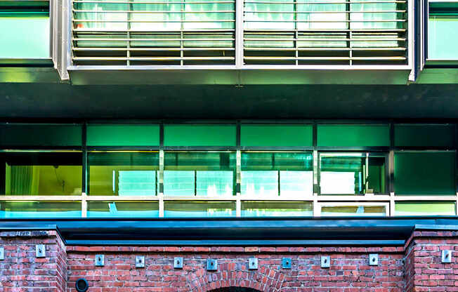 A red brick building with a window and a balcony above it.at Arc Light, San Francisco, CA 94107