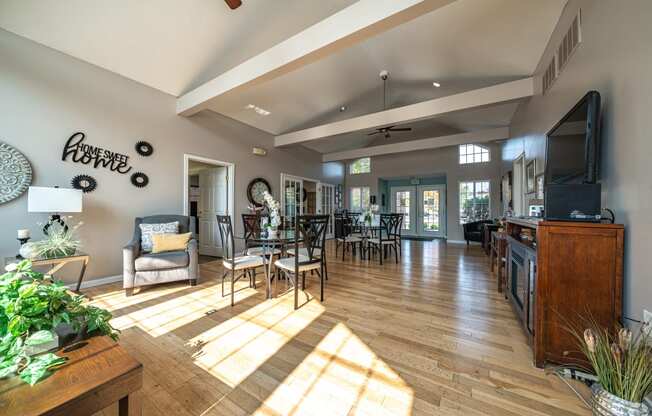 the living room and dining area of a house with wood floors