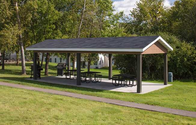 outdoor gazebo with benches underneath it