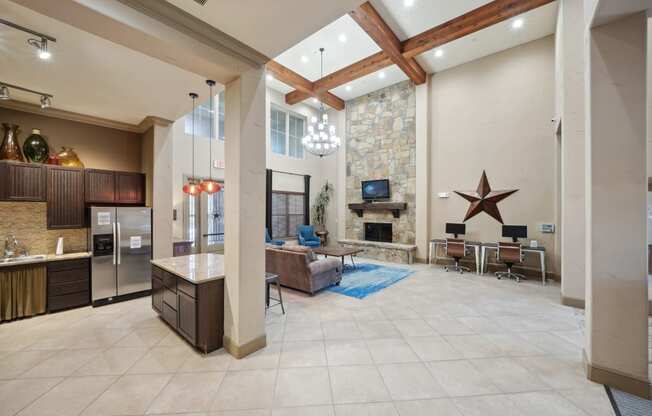 a large living room with a stone fireplace and a tv