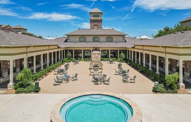 A large building with a pool in front.