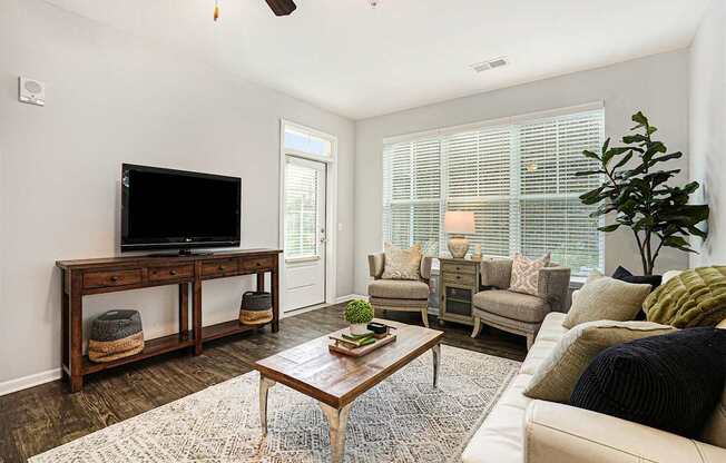 A living room with a television and a couch.