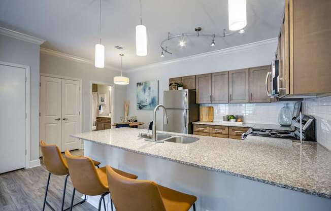 A kitchen with a white counter top and yellow chairs.
