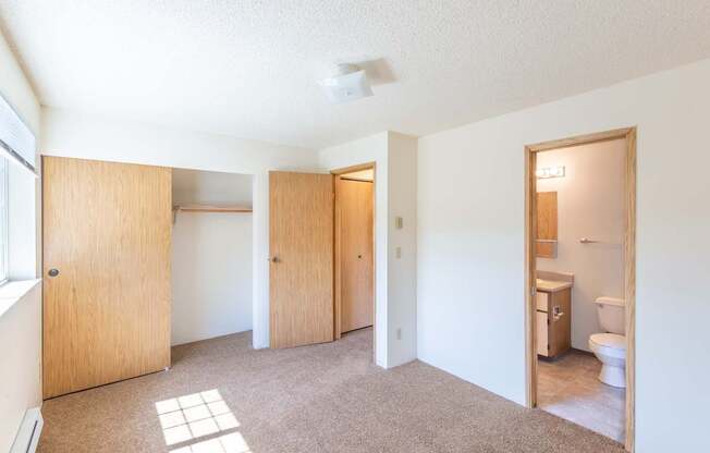 A room with a toilet and a sink.