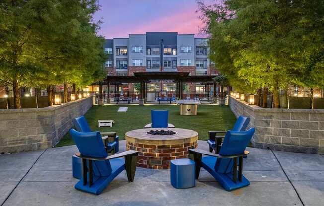 an outdoor patio with chairs and a fire pit