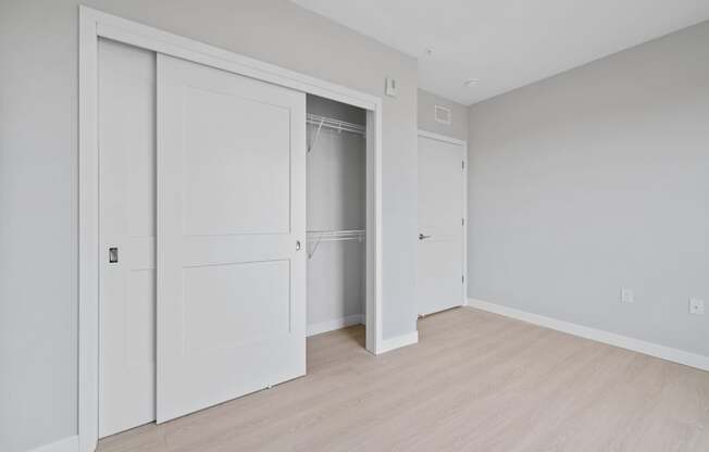 A white door is open to a hallway.