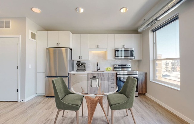 a kitchen and dining room with a table and chairs