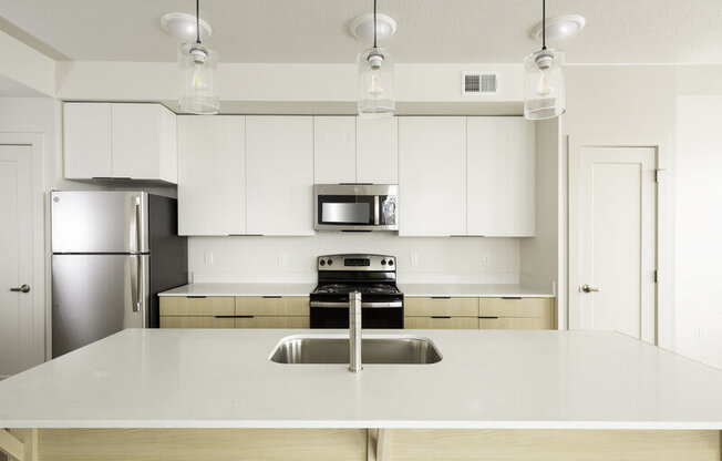 a kitchen with an island counter at Lotus Republic Apartments for rent in Downtown Salt Lake City, Utah