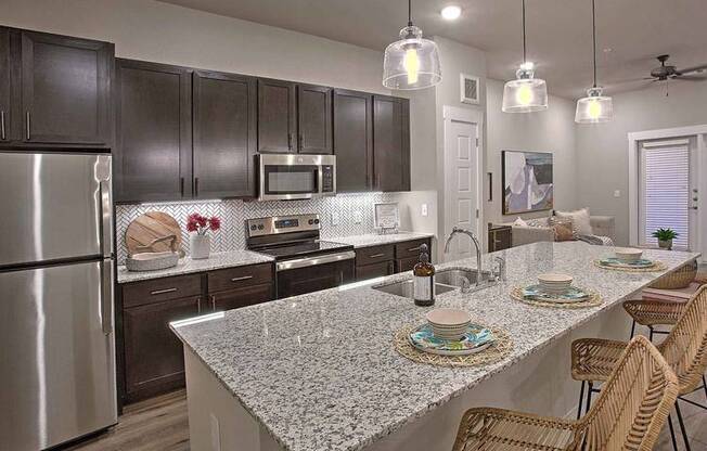 a kitchen with a counter and a table at Hunters Creek Apartments, Texas