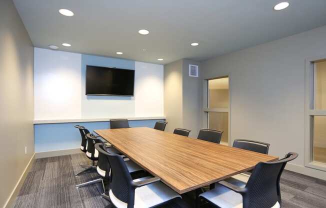 a conference room with a large wooden table and chairs at The Hayes on Stone Way, Seattle, WA, 98103