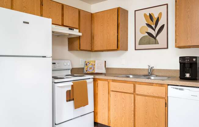 a kitchen with white appliances and wooden cabinets