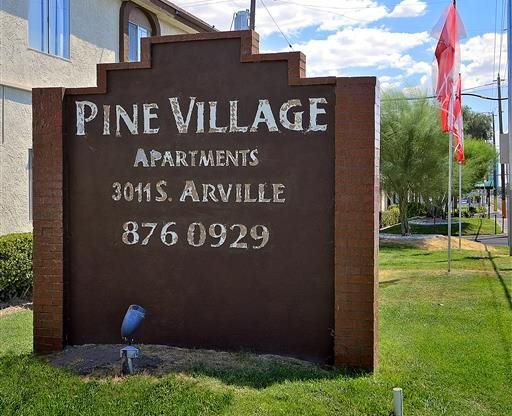 pine village apartments sign