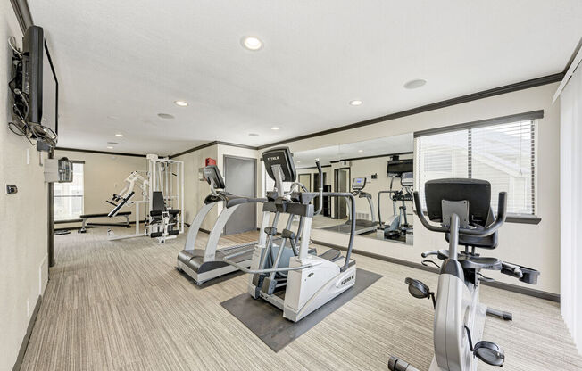 A spacious home gym with a variety of exercise equipment.
