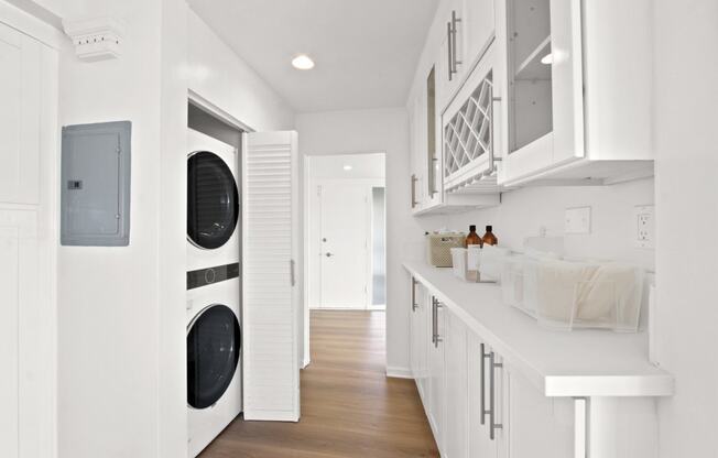 a white laundry room with a washer and a dryer