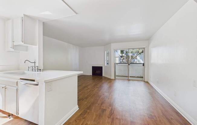 A kitchen with white cabinets and a white sink.