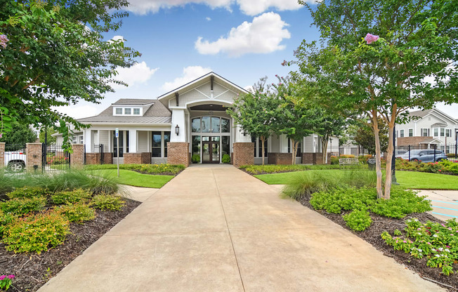 the preserve at ballantyne commons walkway to a building with trees and grass