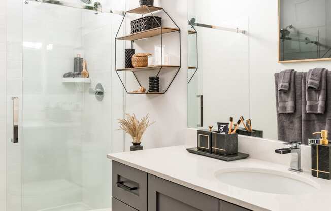 a white bathroom with a shower and a sink and a toilet
