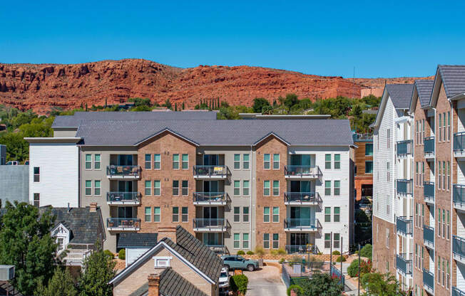 an apartment building with a mountain in the background