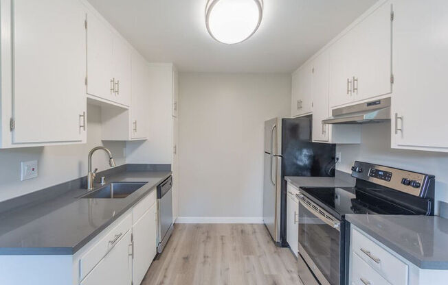 an empty kitchen with stainless steel appliances and white cabinets at Element LLC, Sunnyvale, CA, 94086