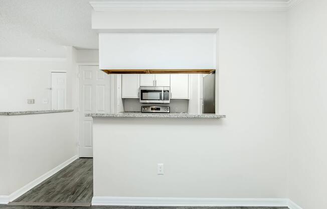 a kitchen with a sink and a mirror