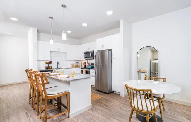 Stylish kitchen with stainless steel appliances and a spacious island perfect for dining and entertaining at Beckett West Fork in Conroe.