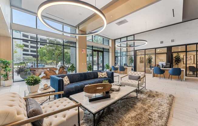 A modern living room with a large window and a variety of seating options.