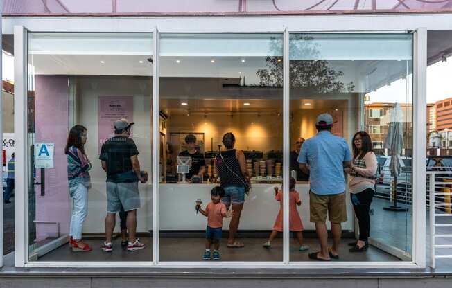 a group of people standing in front of a window