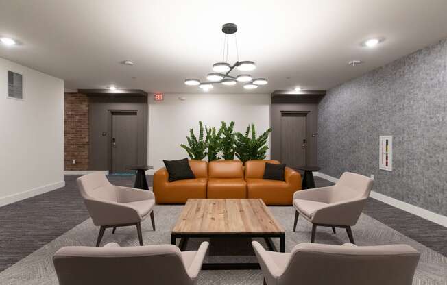 a room with a couch table chairs and a chandelier