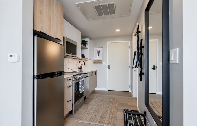 an open kitchen with stainless steel appliances and a door to a hallwayat One Foundry Way, St. Louis, 63110