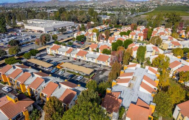 an aerial view of a neighborhood of houses with orange roofs