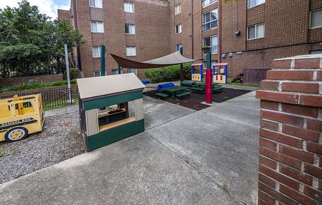 a play area with a hot dog cart in front of an apartment building