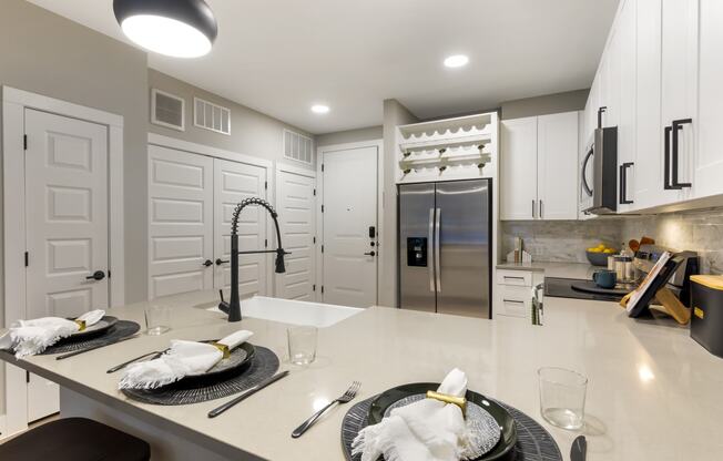 a kitchen with white cabinetry and a large center island with a white countertop