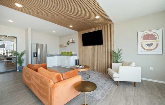 A living room with a couch, chair, and television.