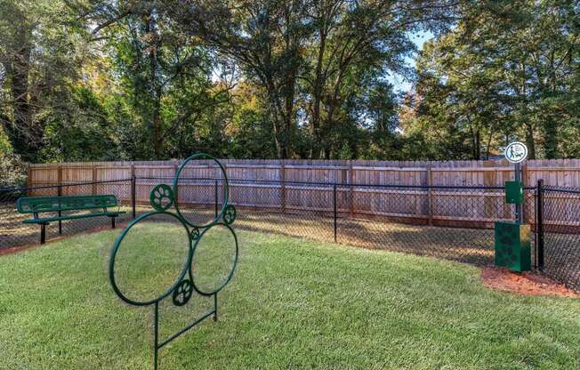 a tennis court in a fenced in area with a bench