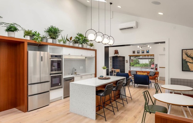 a kitchen with a large island and a table with chairs