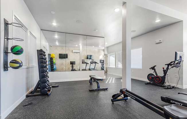 A spartan room with a row of exercise equipment.