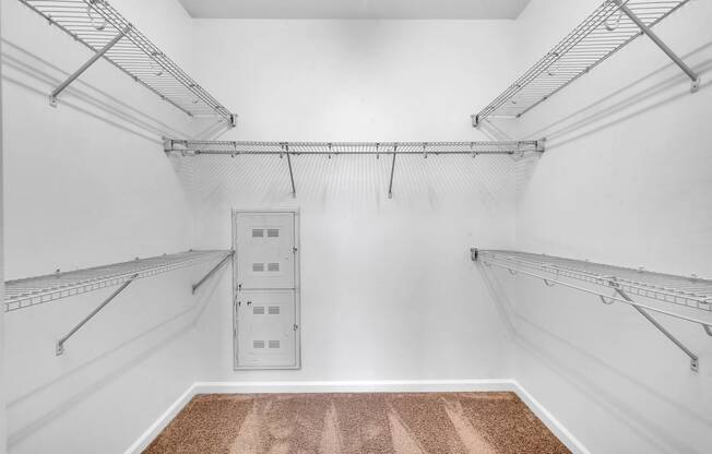 a large room with white walls and a mirrored closet