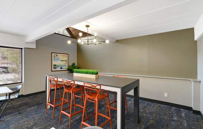 A room with a table and chairs.