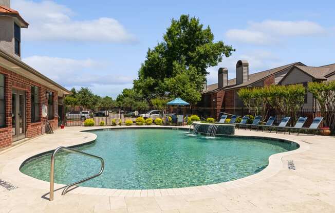 the preserve at ballantyne commons community swimming pool with chairs and building with trees